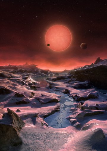 An artist’s illustration depicts an imagined view from the surface of one of the three newfound TRAPPIST-1 alien planets. The planets have sizes and temperatures similar to those of Venus and Earth, making them the best targets yet for life beyond our solar system, scientists say.
(ESO/M. Kornmesser)