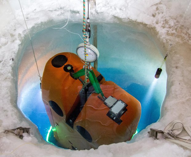 The ARTEMIS submersible vehicle being lowered into the water, where it will descend several kilometers below the McMurdo Ice Shelf.