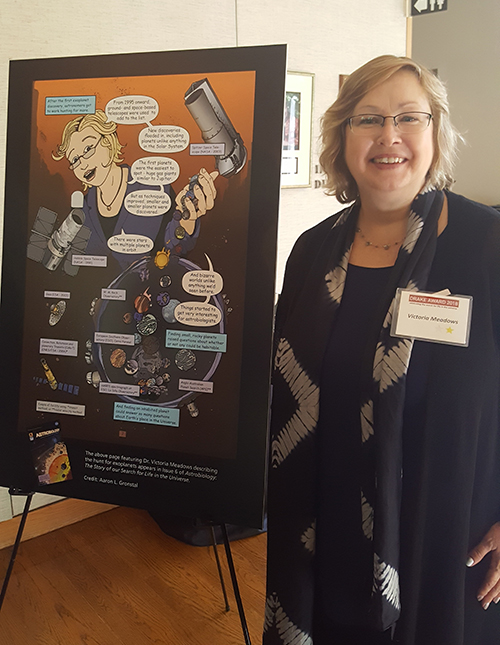 Vikki Meadows standing next to her Astrobiology comic history likeness before the Drake Award ceremony. Image source: Melissa Kirven-Brooks / NAI. Image credit: None