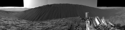 Figure 3.  Slip face on downwind side of Namib sand dune:  This view taken with the Navigation cameras (Navcam) shows the downwind side of the Namib Dune, which stands about 13 feet (~4 meters) high. Namib Dune is part of the Bagnold Dunes, a band of dark sand dunes along the northwest flank of Mount Sharp. These dunes are the first up-close study ever made of active sand dunes outside of Earth. These dunes migrate about one meter per Earth year. 
