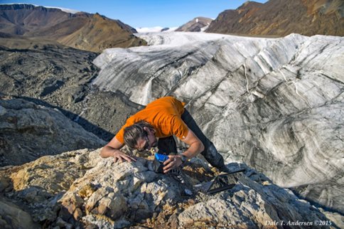 Figure 3. Collecting IR Spectra at the paleospring site - Pablo Sobron using a field-portable IR Spectrometer in an area with chaotic limestone breccia with calcite infillings in pores and calcite veins with sulfides, mostly as pyrite (FeS<sub>2</sub>). In the background is the White Glacier.