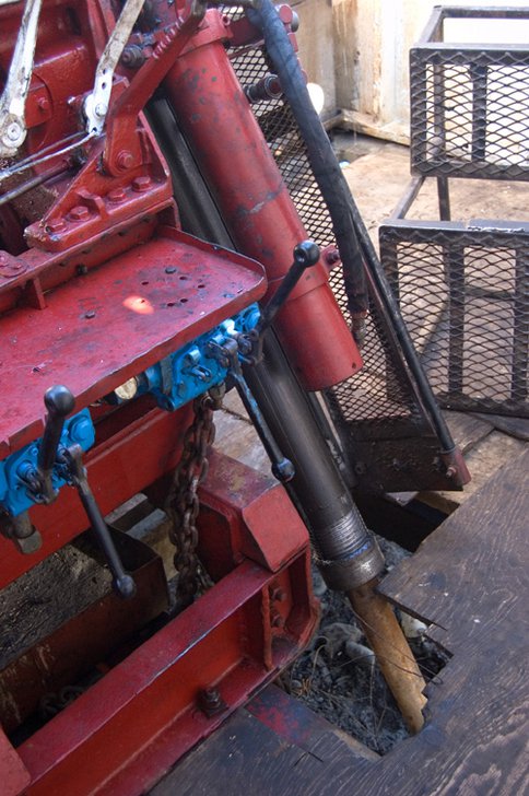 Figure 2. Hydraulic operater controls and can be seen to the left of the drill stem extending downward through the floor. Photo taken by Peter Suchecki as part of project documentation.