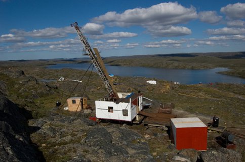 Figure 1. Overview of the mineralized property at High Lake showing the rig in position for drilling a scientific borehole. The orientation of the borehole was inclined as can be seen from the angle of the mast extending above the white housing. Photo taken by Peter Suchecki as part of project documentation.