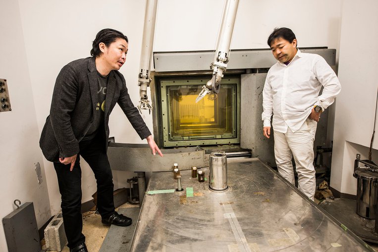 Masashi Aono, left, in the radiation room at the Tokyo Institute of Technology where his team produced formamine by exposing chemicals to radiation.