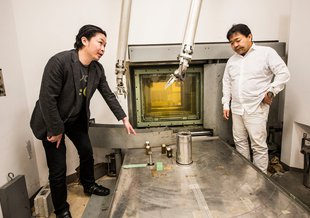 Masashi Aono, left, in the radiation room at the Tokyo Institute of Technology where his team produced formamine by exposing chemicals to radiation.