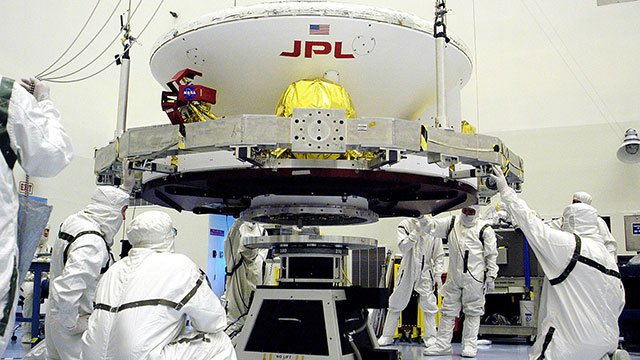 Lifting the Mars Exploration Rover-1 (MER-B) onto a spin table during preflight processing of the spacecraft. Researchers at Cal Poly offer the first biochemical evidence explaining the reason why contamination persist after use of the cleaning facility.