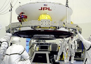 Lifting the Mars Exploration Rover-1 (MER-B) onto a spin table during preflight processing of the spacecraft. Researchers at Cal Poly offer the first biochemical evidence explaining the reason why contamination persist after use of the cleaning facility.