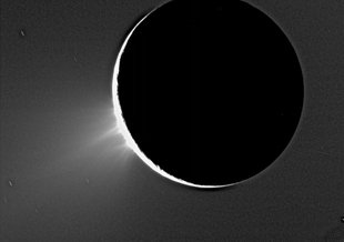 Enceladus backlit by the sun show the fountain-like sources of the fine spray of material that towers over the south polar region. This image was acquired on Nov. 27, 2005.