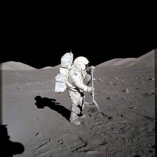 Scientist-astronaut Harrison H. Schmitt, Apollo 17 lunar module pilot, collects lunar rake samples at Station 1 during the mission's first spacewalk at the Taurus-Littrow landing site. Photo by commander Eugene A. Cernan.