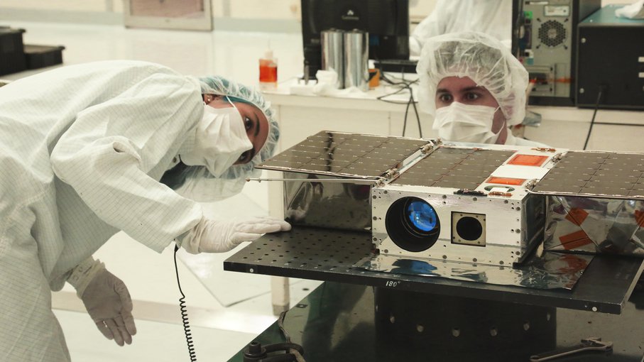 Electrical Test Engineer Esha Murty and Integration and Test Lead Cody Colley prepare the ASTERIA spacecraft for mass-properties measurements in April 2017. ASTERIA was deployed from the International Space Station in November 2017.