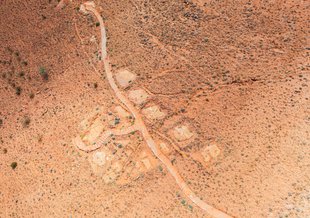 A nearly direct overhead view of the fossil site at Nilpena. tracks and paths can be seen on bare earth with some small scrubs visible as the only plant life.