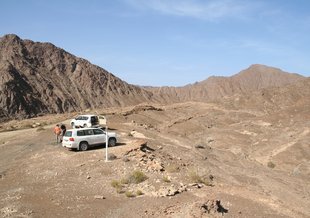 Scientists survey the peridotite landscape and obtaining access to deep wells drilled into peridotite.