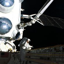 CGRO looms over STS-37 Mission Specialist Jay Apt as he works his way along the payload bay of space shuttle Atlantis. The unscheduled EVA was needed to free Compton's high-gain antenna, which was stuck in its launch configuration.