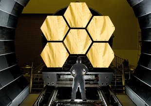 NASA engineer Ernie Wright looks on as the first six flight ready James Webb Space Telescope primary mirror segments are prepped to begin final cryogenic testing at NASA's Marshall Space Flight Center. Credit: NASA/MSFC/David Higginbotham 