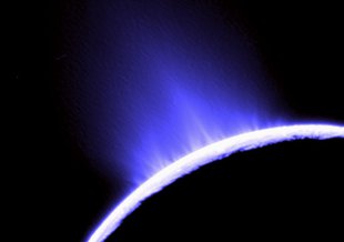 This false color photo of water geysers spouting from Saturn’s moon Enceladus was taken by NASA’s Cassini. The geysers establish that there is a subsurface ocean beneath the icy crust of the moon.