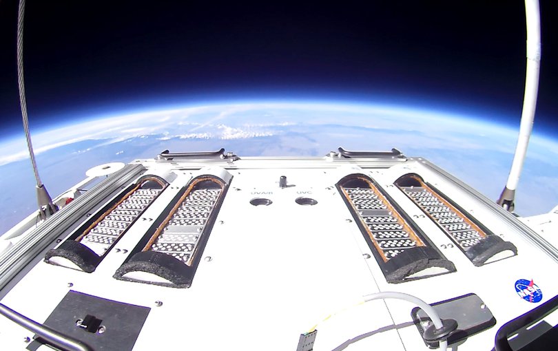 Hardware carrying the second Exposing Microorganisms in the Stratosphere experiment is seen floating 19 miles above the Earth aboard a NASA scientific balloon.