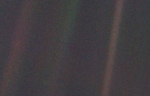 The iconic “pale blue dot” image of Earth taken by the Voyager 1 spacecraft, from a distance of 3.7 billion miles in 1990. Earth is the speck halfway down the brownish streak to the right. The streaks are artifacts, caused by the scattering of sunlight in