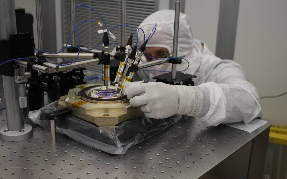 Optics engineer Greg Balonek prepares a TESS flight lens for modal testing at MIT Lincoln Laboratory.