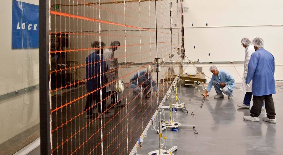 Technicians test the deployment of one of the three massive solar arrays that will power NASA's Juno spacecraft.