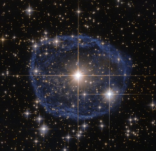 A distinctive blue bubble appears to encircle the star WR 31, and is a Wolf–Rayet nebula, an interstellar cloud of dust, hydrogen, helium and other gases. It is created when stellar winds interact with the outer layers of hydrogen ejected by the star.