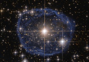 A distinctive blue bubble appears to encircle the star WR 31, and is a Wolf–Rayet nebula, an interstellar cloud of dust, hydrogen, helium and other gases. It is created when stellar winds interact with the outer layers of hydrogen ejected by the star.