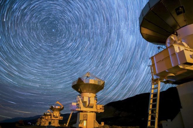 A screenshot from a time lapse video of radio telescopes by Harun Mehmedinovic and Gavin Heffernan of Sunchaser Pictures that was shot at several different radio astronomy facilities—the Very Large Array (VLA) Observatory in New Mexico, Owens Valley Observatory in Owens Valley California, and Green Bank Observatory in West Virginia. All three of these facilities have been or are still being partly used by the SETI (Search for the Extraterrestrial Intelligence) program.