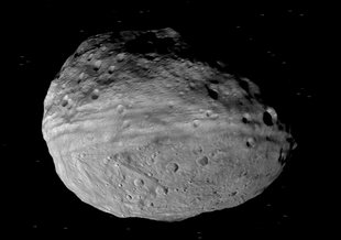 This artist's concept shows NASA's Dawn spacecraft orbiting the giant asteroid Vesta. The depiction of Vesta is based on images obtained by Dawn's framing cameras. Image credit: NASA/JPL-Caltech 