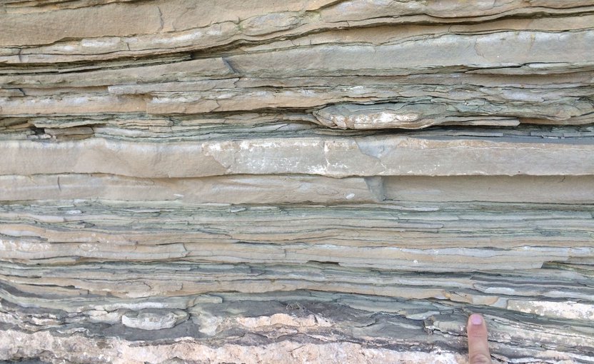 Close-up view of layered sedimentary rocks representative of those used in this study. Each layer records a snapshot of the Earth system over millions to billions of years.