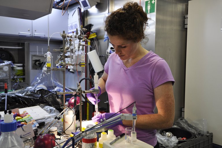 Jill McDermott performing a chemical analysis called titration to analyze the hydrogen sulfide content of vent fluid samples onboard the R/V Falkor in 2013.