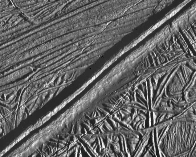 A double ridge cutting across the surface of Europa is seen in this mosaic of two images taken by NASA’s Galileo during the spacecraft’s close flyby on Feb. 20, 1997.