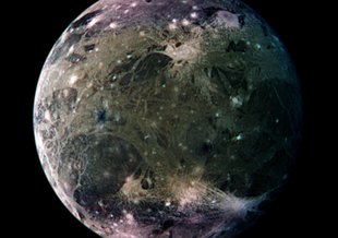 Galileo image of the trailing hemisphere of Jupiter's moon Ganymede. The north and south polar areas can be distinguished by their light purple shade in this image.