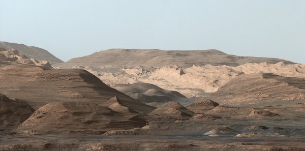 This composite image looking toward the higher regions of Mount Sharp was taken on September 9, 2015, by NASA's Curiosity rover. In the foreground - about 2 miles (3 kilometers) from the rover - is a long ridge teeming with hematite, an iron oxide.