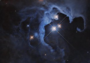 Three bright stars with diffraction spikes shine near the center-right of the image, illuminating nearby clouds that glow in pale blue. The clouds darken at the edges of the image, and are dotted with smaller stars, some also with diffraction spikes.
