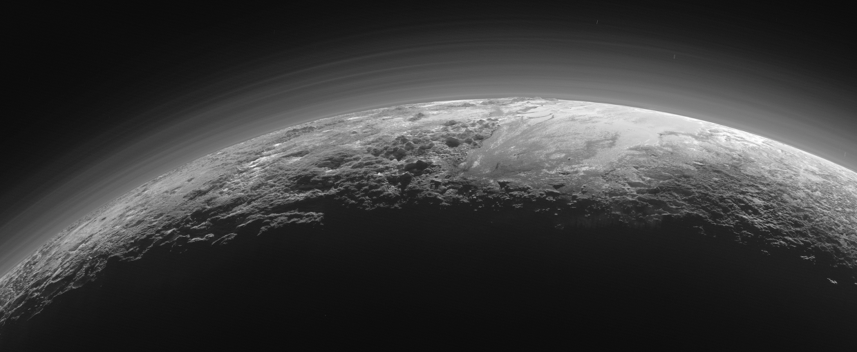 Pluto’s Majestic Mountains, Frozen Plains and Foggy Hazes: 15 minutes after its closest approach to Pluto, New Horizons captured this near-sunset view of the rugged, icy mountains and flat ice plains extending to Pluto’s horizon.