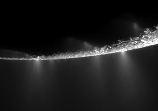 Plumes erupting off the surface of Enceladus, an icy moon.