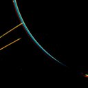 Jupiter's faint ring system is shown in this color composite as two light orange lines protruding from the left toward Jupiter's limb. This picture was taken in Jupiter's shadow through orange and violet filters by the Voyager 2 spacecraft.