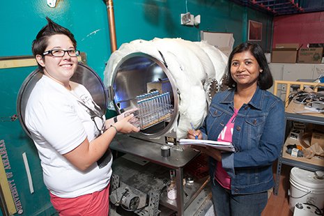 Graduate students Rebecca Mickol and Navita Sinha prepare to load methanogens into the Pegasus Chamber housed in W.M. Keck Laboratory.
