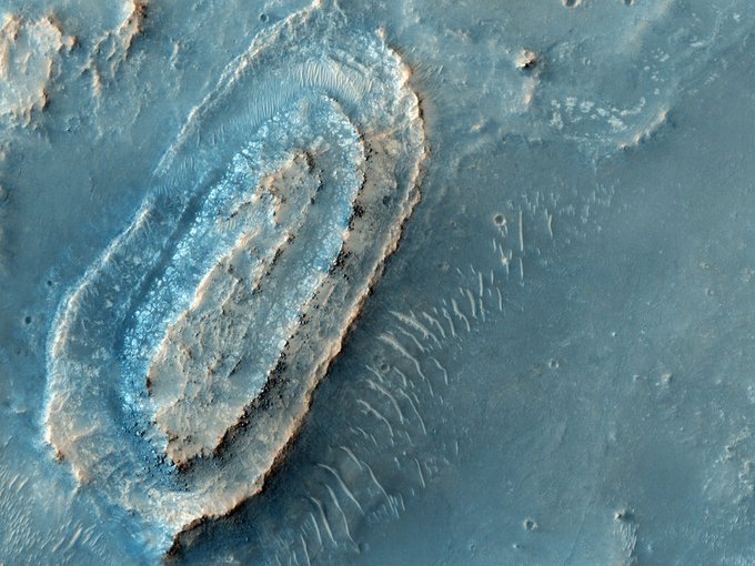 Candidate Landing Site in NE Syrtis Major. This image lies in the middle of a candidate landing site in the Northeast part of Syrtis Major, a huge shield volcano, and near the Northwest rim of Isidis Planitia, a giant impact basin. This region exposes Early Noachian bedrock, more than 4 billion years old, and contains a diversity of hydrated minerals. This would be an excellent place to explore early Mars, when the environment may have been conducive to life. HiRISE images will help determine if this spot is sufficiently safe for landing--not too many boulders or steep slopes. If it is safe, it may be considered for the 2011 Mars Science Laboratory or the 2018 rovers from Europe and the United States. Image Credit: NASA/JPL-Caltech/University of Arizona