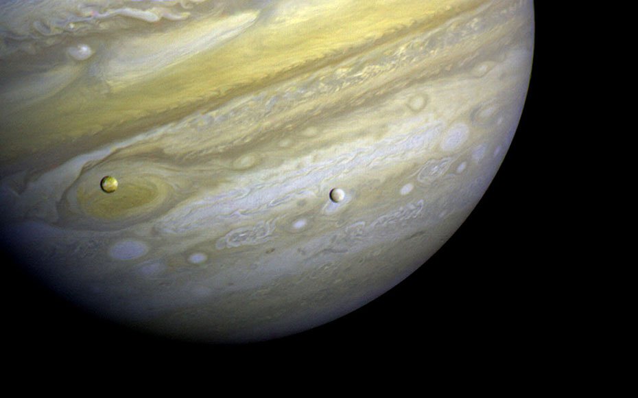 Voyager 1 took this photo of Jupiter and two of its satellites (Io, left, and Europa) on Feb. 13, 1979.
