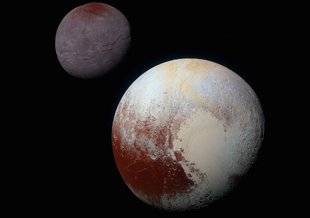 This composite of enhanced color images of Pluto (lower right) and Charon (upper left), was taken by NASA’s New Horizons spacecraft as it passed through the Pluto system on July 14, 2015. This image highlights the striking differences between them.