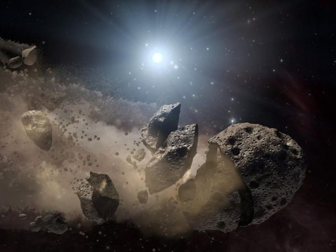 Artist concept of an asteroid breaking up.