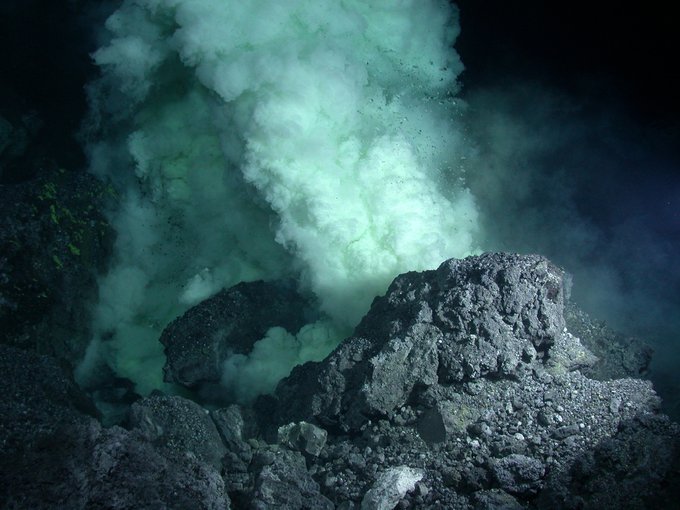 Lava erupts onto the seafloor at NW Rota-1, creating a cloudy, extremely acidic plume.