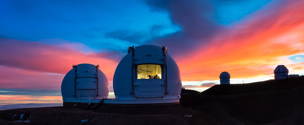 Keck I open for buisness as the Hawaiian sun sets on the horrizon, filling the sky with a beautiful mix of blue, pink, and orange.