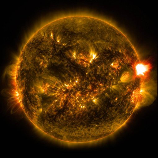 A solar flare erupting from the right side of the sun.