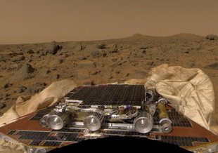 One of the first missions of the Discovery Program, the Mars Pathfinder and its rover, Sojourner, are seen on the red planet soon after their landing on July 4, 1997.
