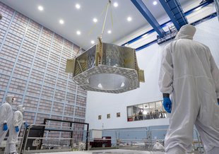 Roman's primary structure hangs from cables as it moves into the big clean room at NASA's Goddard Space Flight Center.