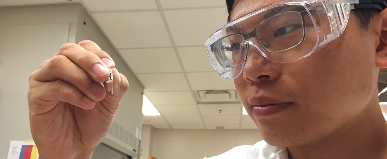 Georgia Tech graduate student Sheng-Sheng Yu holds a sample that has been subjected to repeated cycles of wet-dry conditions. From amino acids and hydroxy acids, the process results in a mixture of polyesters and peptides containing as many as 14 units. C