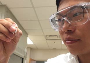 Georgia Tech graduate student Sheng-Sheng Yu holds a sample that has been subjected to repeated cycles of wet-dry conditions. From amino acids and hydroxy acids, the process results in a mixture of polyesters and peptides containing as many as 14 units. C