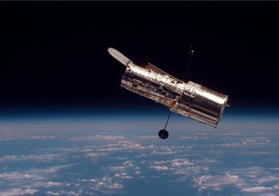 Hubble as seen from Discovery during its second servicing mission.