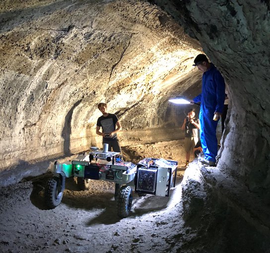 NASA's robotics team drives the test rover, CaveR, into Valentine Cave at Lava Beds National Monument.